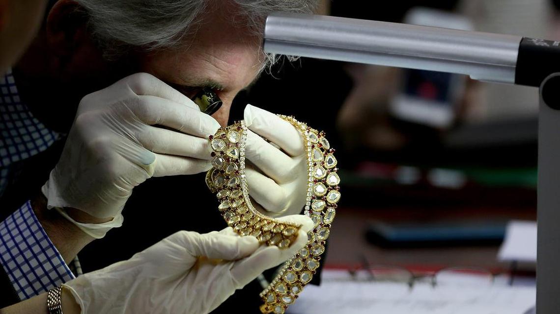 Christie’s auction house appraiser David Warren examines a set of jewelry from Roumeliotes Collection, one of three sets of the Marcos Jewelry Collection, during appraisal at the Central Bank of the Philippines Tuesday in Manila. The Philippine government is having millions of dollars’ worth of jewelry seized from former first lady Imelda Marcos appraised Tuesday ahead of a possible auctioning of the collection. The jewelry was seized when Marcos’ family fled to Hawaii in 1986 following a revolt that ended her husband’s two decades in power.