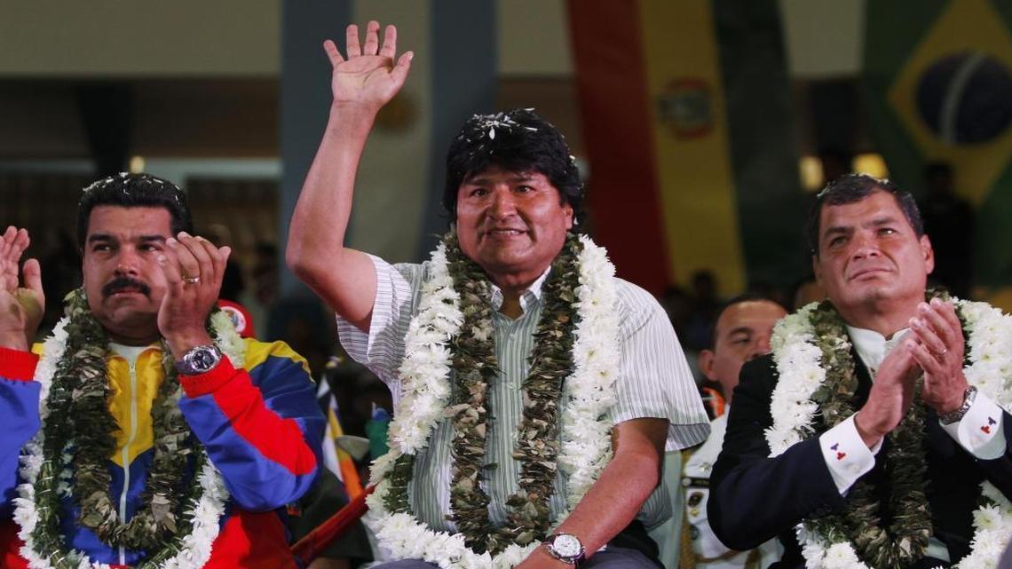Venezuela's President Nicolas Maduro, left, Ecuador's President Rafael Correa, right, and Bolivia's President Evo Morales acknowledge supporters during a welcome ceremony for presidents attending an extraordinary meeting in Cochabamba, Bolivia, Thursday , July 4, 2013.