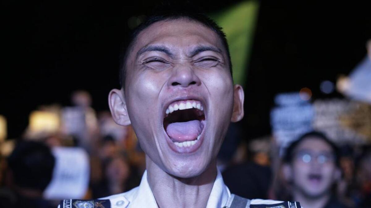 A protester shouts slogans as he joins a rally at Manila's Rizal Park, Philippines Friday Nov. 25, 2016. Thousands of Filipinos, including more than a dozen nude students, protested Friday against the hasty burial of Philippine dictator Ferdinand Marcos in a heroes' cemetery, in a growing political storm that's lashing the president who allowed the entombment.