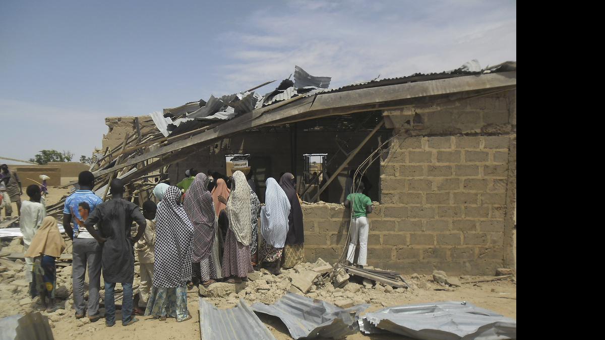 
People gather at the site of suicide bomb attack at Redeem Christian church in Potiskum, Nigeria, Sunday, July 5, 2015. Witnesses say a woman suicide bomber blew up in the midst of a crowded evangelical Christian church service on Sunday and killed at least five people, the latest in a string of bombings and shooting attacks blamed on the Islamic extremist group Boko Haram that has killed some 200 people in the past week. 
