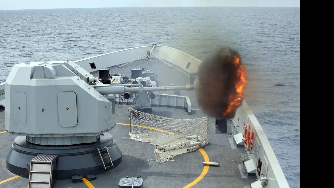 
In this May 24, 2015, photo released by China's Xinhua News Agency, an anti-surface gunnery is fired from China's Navy missile frigate Yulin during the "Exercise Maritime Cooperation 2015" by Singapore and Chinese navies in the South China Sea. The dispute over the strategic waterways of the South China Sea has intensified, pitting a rising China against its smaller and militarily weaker neighbors who all lay claim to a string of isles, coral reefs and lagoons known as the Spratly and the Paracel islands.
