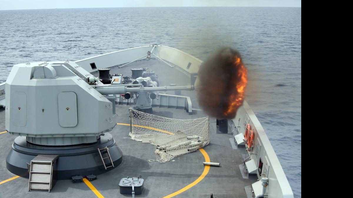 
In this May 24, 2015, photo released by China's Xinhua News Agency, an anti-surface gunnery is fired from China's Navy missile frigate Yulin during the "Exercise Maritime Cooperation 2015" by Singapore and Chinese navies in the South China Sea. The dispute over the strategic waterways of the South China Sea has intensified, pitting a rising China against its smaller and militarily weaker neighbors who all lay claim to a string of isles, coral reefs and lagoons known as the Spratly and the Paracel islands.
