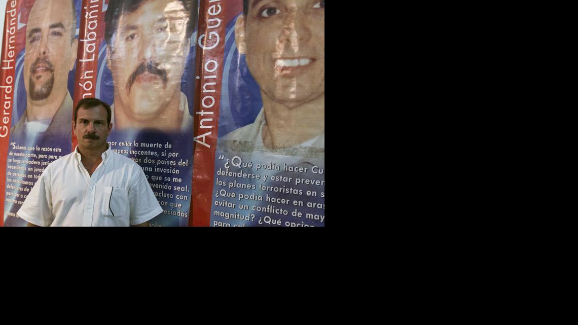 
Cuban intelligence agent Fernando Gonzalez, known as one of the "Cuban Five," poses for a portrait on June 2, 2014, in front of a poster showing the three Cuban intelligence agents imprisoned in the U.S, from left, Gerardo Hernandez, Ramon Labanino, and Antonio Guerrero after a press conference in Havana, Cuba. The three Cubans were released by the U.S. on Wednesday, Dec. 17, 2014 in exchange for U.S. citizen Alan Gross from Cuba. They're part of the so-called Cuban Five - a group of men who were part of the "Wasp Network" sent by Cuba's then-President Fidel Castro to spy in South Florida. Two of the Cuban Five, including Gonzalez, were previously released after finishing their sentences. 
