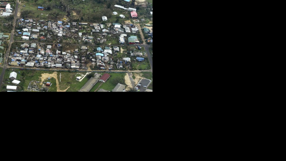 
Damage to houses in Port Vila, Vanuatu is seen from the air in the aftermath of Cyclone Pam Monday, March 16, 2015. Vanuatu's President Baldwin Lonsdale said Monday that the cyclone that hammered the tiny South Pacific archipelago over the weekend was a "monster" that has destroyed or damaged 90 percent of the buildings in the capital and has forced the nation to start anew.
