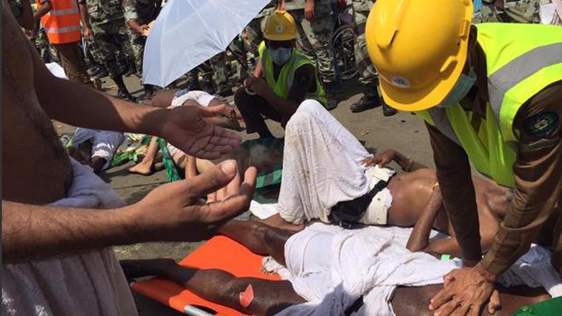 
In this image posted on the official Twitter account of the directorate of the Saudi Civil Defense agency, a pilgrim is treated by a medic after a stampede that killed and injured pilgrims in the holy city of Mina during the annual hajj pilgrimage on Thursday, Sept. 24, 2015. 
