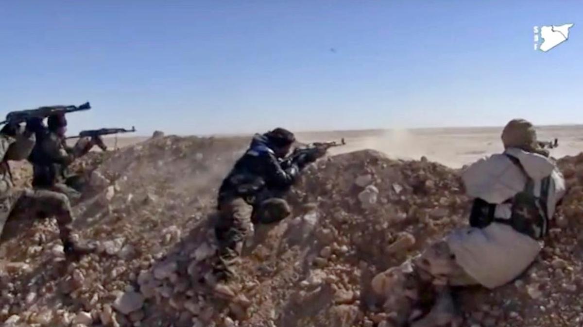 This frame grab from a video provided by the Syria Democratic Forces (SDF), shows fighters from the SDF opening fire on an Islamic State group's position, in Raqqa's eastern countryside, Syria, Monday, March 6, 2017.