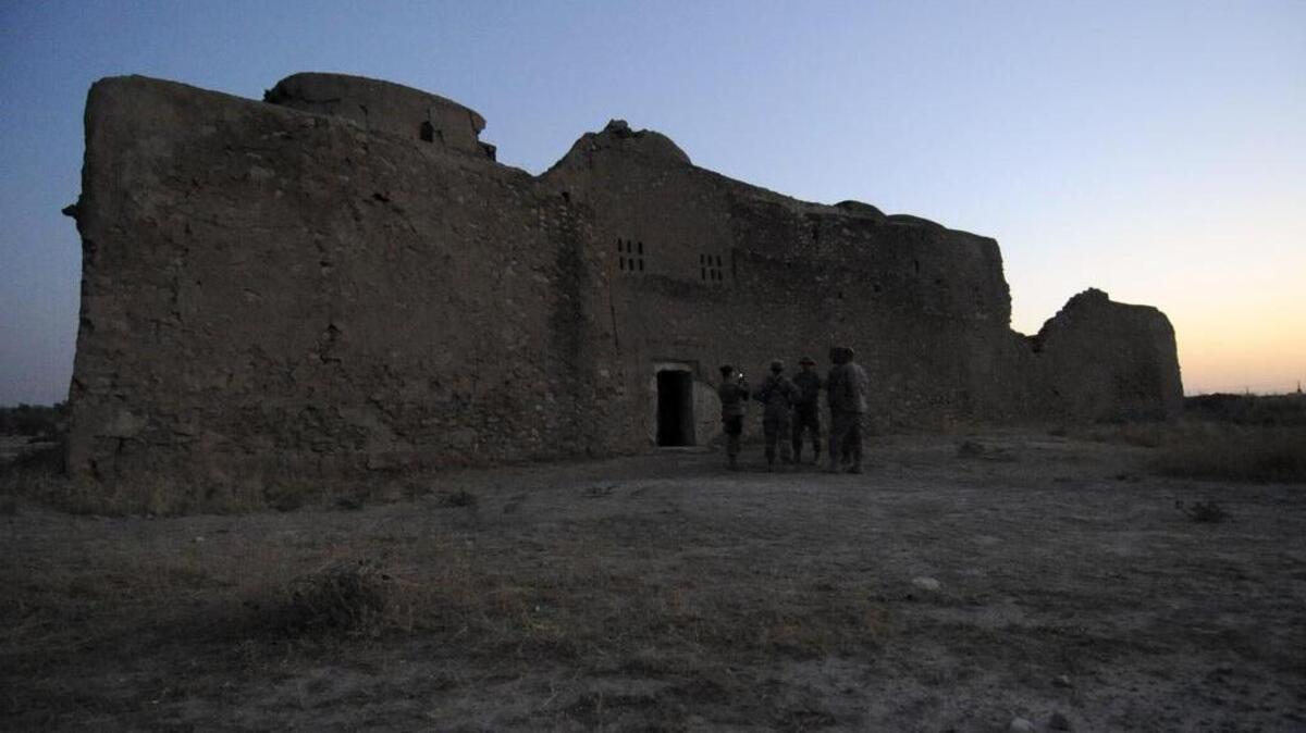 In this Aug. 21, 2009, photo released by the U.S. Army, visitors assigned to the Logistic Civil Augmentation Program from Forward Operating Base Speicher, near Tikrit, Iraq, stand at the entrance to the ruins of St. Elijah’s Monastery after completing a tour there, at Forward Operating Base Marez in Mosul, Iraq.