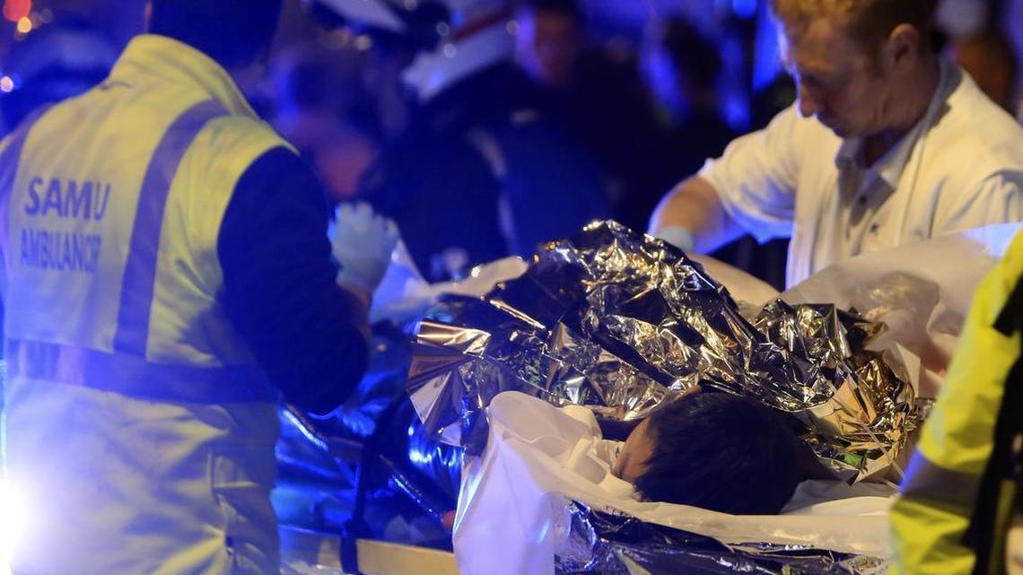 A person is evacuated from the Bataclan after a shooting in Paris Nov. 13, 2015. French President Francois Hollande declared a state of emergency and announced that he was closing the country's borders.
