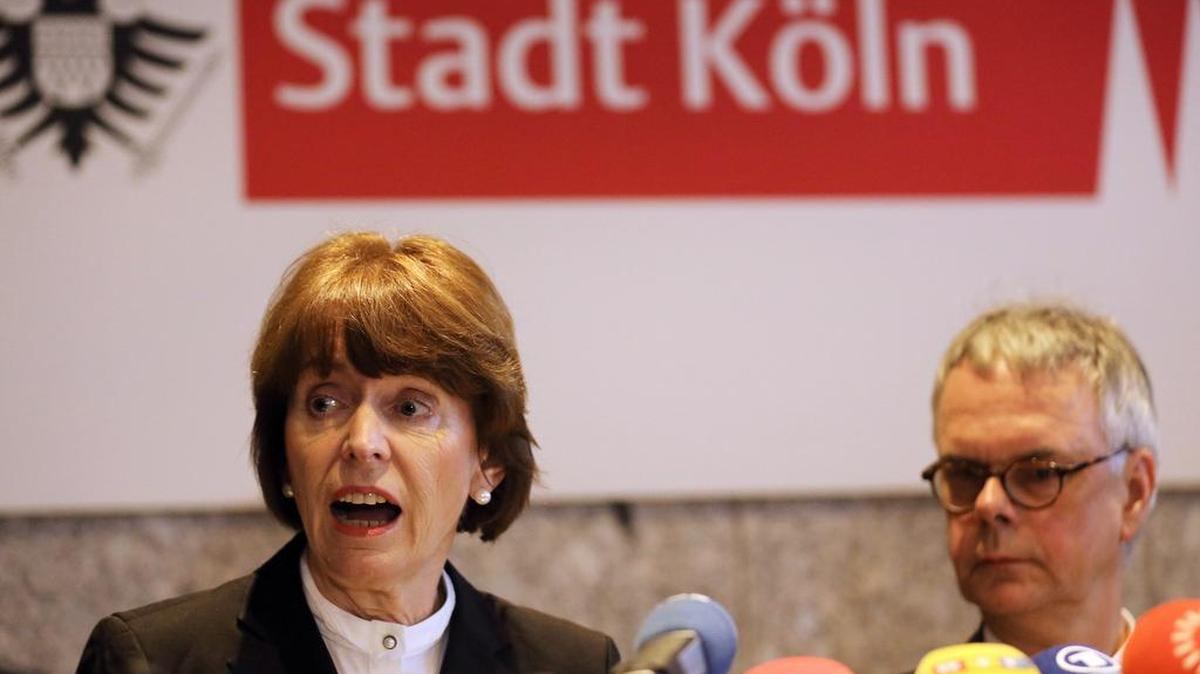 Cologne mayor Henriette Reker , left, and the head of Cologne's police, Wolfgang Albers, attend a news conference in Cologne, western Germany, Jan. 5, 2016. The mayor of Cologne condemned a series of sexual assaults in the western German city on New Year's Eve, calling for the perpetrators to be "prosecuted in the toughest possible way."