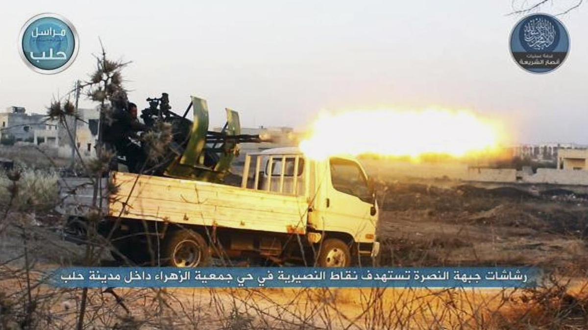 
In this file image posted on a Twitter account of Syria’s al-Qaida-linked Nusra Front early Tuesday, July 7, 2015, a fighter from the Nusra Front fires a weapon during clashes against the Syrian government forces at the western Zahra neighborhood in Aleppo, Syria. A group of U.S.-trained rebels that recently returned to Syria said Wednesday it has lost contact with one of its officer but is investigating reports that it has defected and handed over his weapons to al-Qaida affiliate in the country. (Al-Nusra Front via AP, File)
