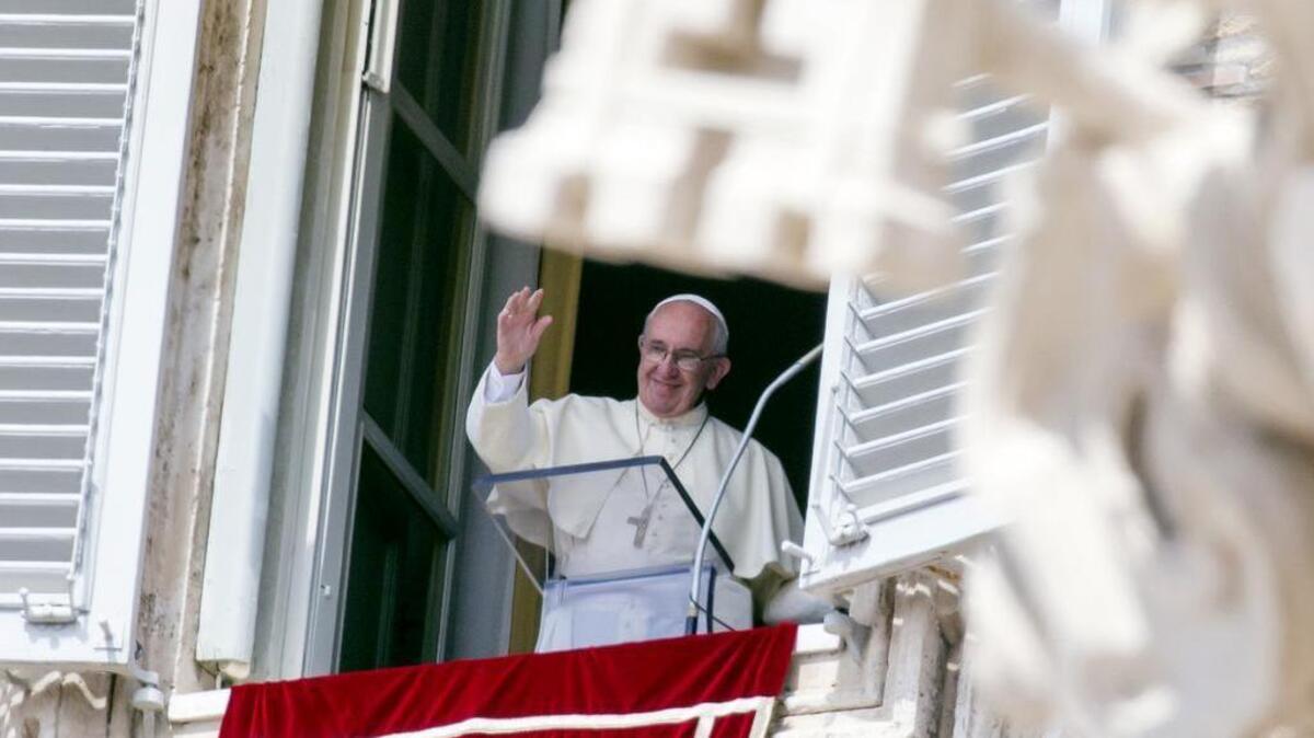 
Pope Francis waves to faithful as he arrives to recite the Angelus noon prayer from his studio window overlooking St. Peter’s Square at the Vatican, Sunday, Sept. 6, 2015. The Vatican will shelter two families of refugees “who are fleeing death” from war or hunger, Pope Francis announced Sunday as he called on Catholic parishes, convents and monasteries across Europe to do the same. 
