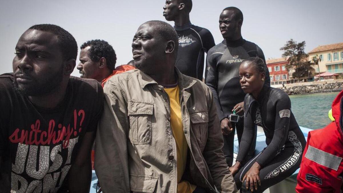 Student Adama Athie, left, sits next to Ibrahima Thiaw, 50, center, and fellow students, Djidere Balde, Madick Gueye, Pape Leity Diop and Aicha Kamite off the shore of Goree Island in Dakar, Senegal in May.