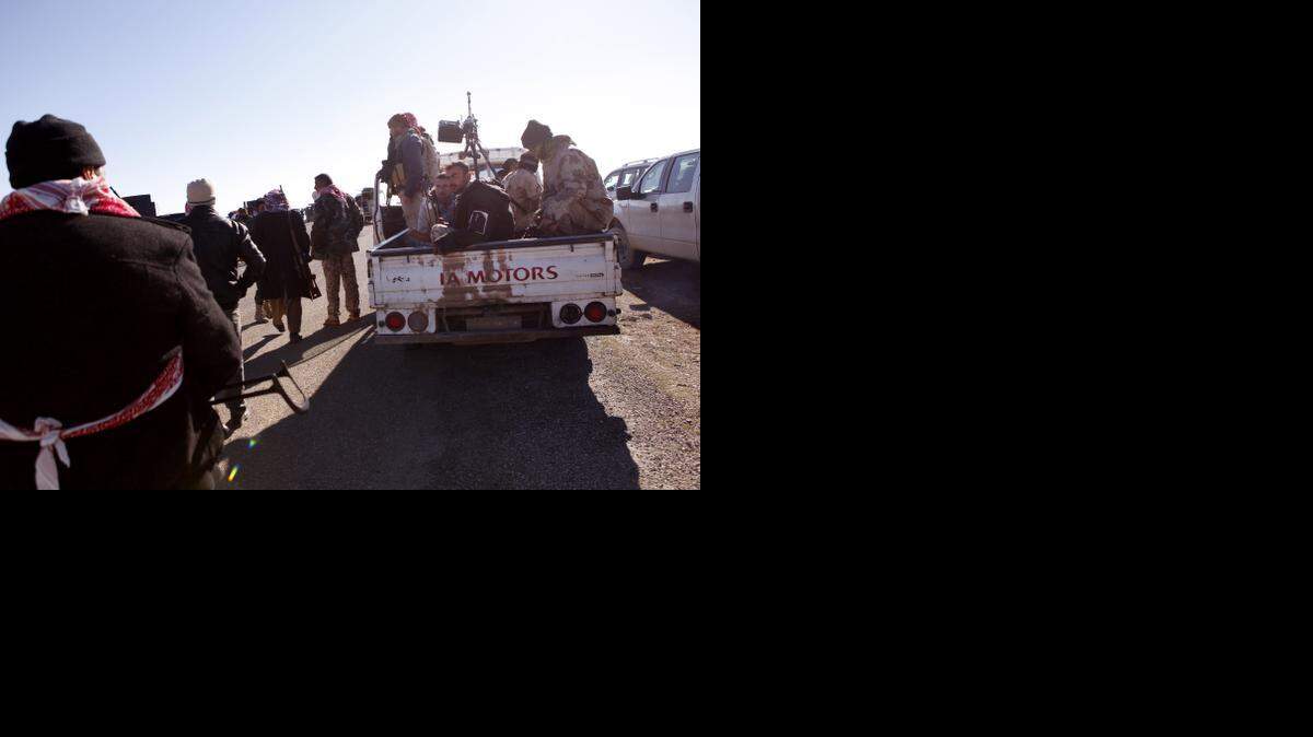 
 Iraqi Kurdish forces head to battle Islamic State militants, on the summit of Mount Sinjar, in Iraq on Dec. 21, 2014. Last year, a Syrian rebel group called on the new U.S. special envoy for Syria with an outline of a plan to stop the extremists, but says there was no response.



