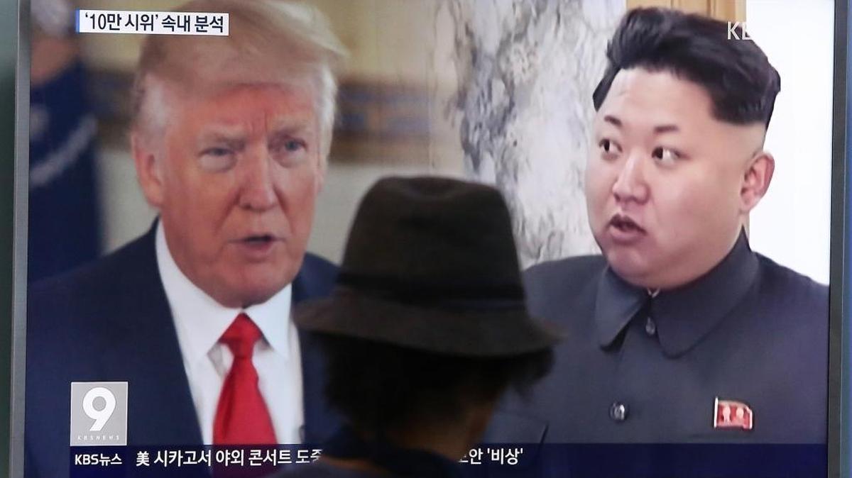 A man watches a television screen showing President Donald Trump and North Korean leader Kim Jong Un during a news program at the Seoul Train Station in Seoul, South Korea, Thursday, Aug. 10, 2017.
