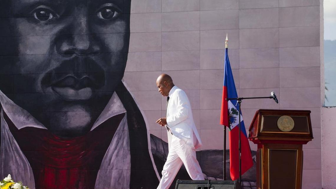Haiti President Michel Martelly returns to his seat in October after delivering a speech during a ceremony marking the 209th anniversary of the assassination of independence hero Gen. Jean-Jacques Dessalines, in Port-au-Prince, Haiti. The outgoing president released on Sunday a song jeering at his critics, primarily an award-winning female journalist and human rights advocate. The released track called “Bal Bannann Nan”, Haitian Creole for “Give Them the Banana.” It’s credited to Sweet Micky, the stage name for Haiti's pop-star-turned-president.