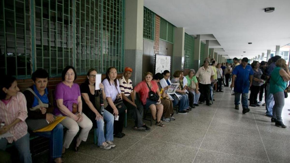People line up inside of a school set up as a validation center to certify the authenticity of their signatures in Caracas, Venezuela, on Monday, June 20, 2016. Venezuela starts a crucial stage in the possible recall referendum against President Nicolas Maduro with the validation of 1.3 million signatures supporting the referendum.