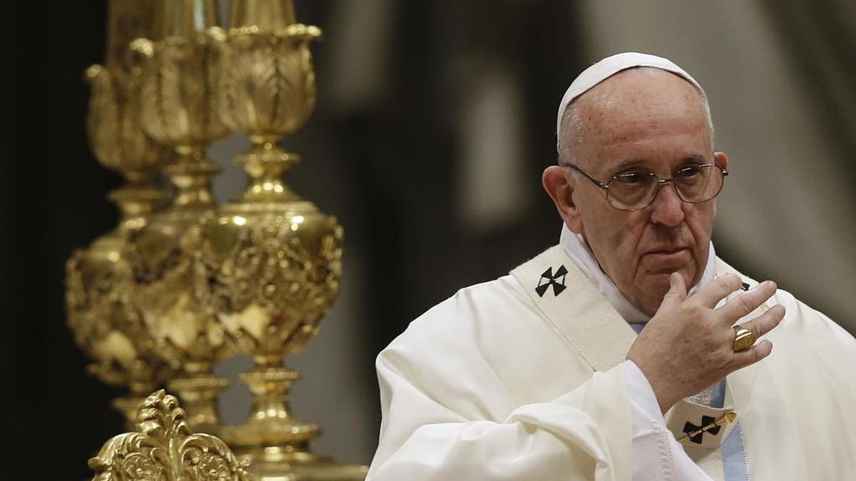 Pope Francis makes the sign of the cross as he celebrates a New Year mass in St. Peter’s Basilica at the Vatican, on Friday, Jan. 1, 2016.
