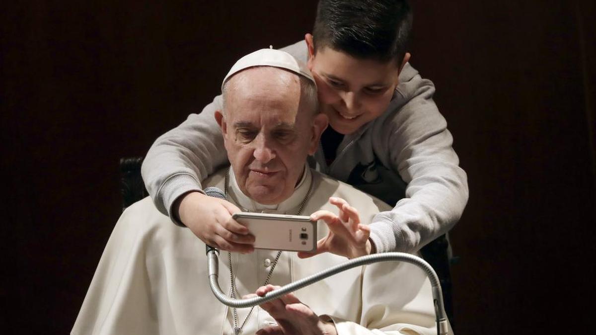 A boy takes a selfie with Pope Francis, during a visit to the parish of Santa Maria Josefa del Cuore di Gesu', in Rome, Sunday, Feb. 19, 2017.