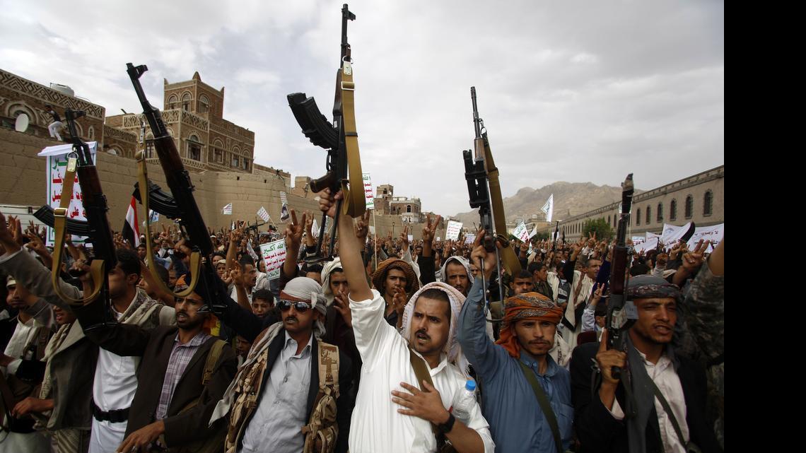 
Shiite rebels known as Houthis hold up their weapons as they chant slogans during a rally against Saudi-led airstrikes in Sanaa, Yemen. 
