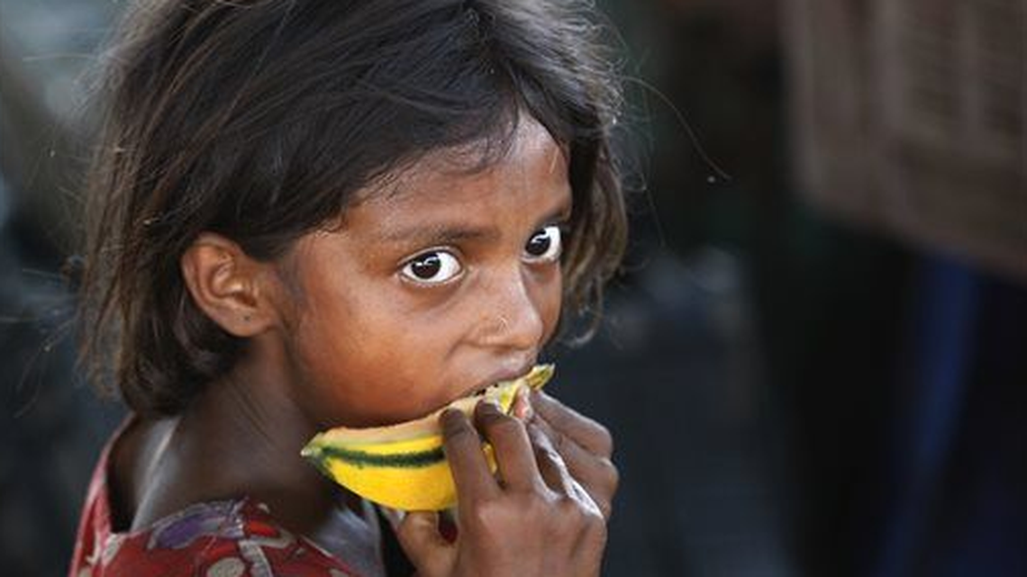 An Indian child laborer eats a piece of a muskmelon on the World Day against Child Labor on the outskirts of Jammu, India. Despite the country’s rapid economic growth, child labor remains widespread in India, where an estimated 13 million children work, with laws meant to keep kids in school and out of the workplace routinely flouted.