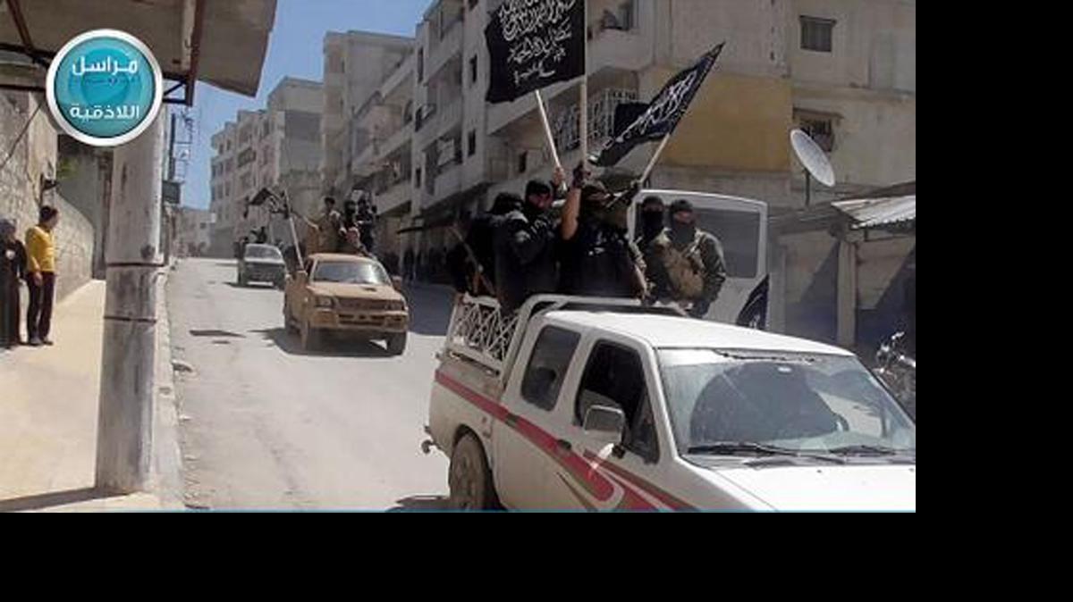 
This image posted on the Twitter page of Syria's al-Qaida-linked Nusra Front on Saturday April 25, 2015, which is consistent with AP reporting, shows Nusra Front fighters standing on their vehicles and waving their group's flags as they tour the streets of Jisr al-Shughour, Idlib province, Syria. 
