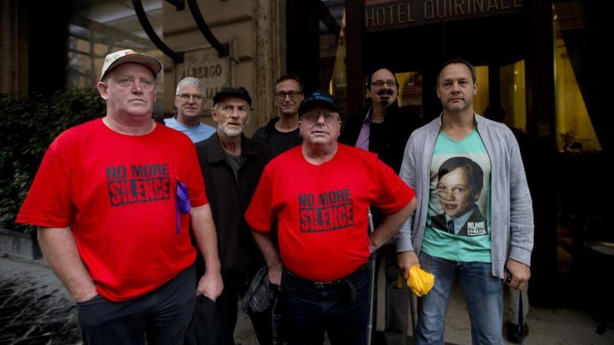 From left, Dominic Ridsdale, Phil Nagle, Paul Auchettl, David Ridsdale, Tony Waroley, Stephen Woods and Peter Blenkiron, survivors and relatives of priestly sex abuse, stand in front of the Quirinale hotel in Rome, on Sunday, Feb. 28, 2016. Australians who were raped and molested by priests are hoping to learn the truth about what a top Vatican cardinal knew about their attackers when he testifies before an investigative commission at a Rome hotel conference room.