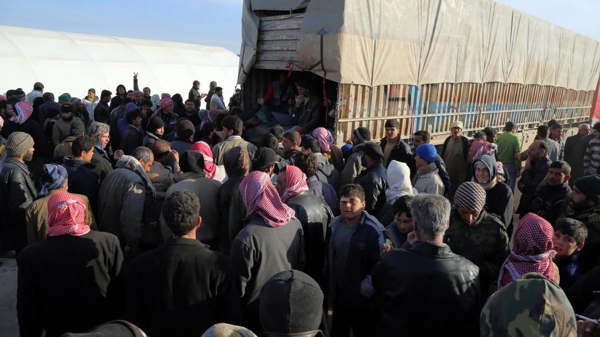 In this photo provided by Turkey’s Islamic aid group of IHH, Syrians fleeing the conflicts in Azaz region, congregate at the Bab al-Salam border gate on Friday, Feb. 5, 2016. Turkish officials say thousands of Syrians have massed on the Syrian side of the border seeking refuge in Turkey. Officials at the government’s crisis management agency said Friday it was not clear when Turkey would open the border to allow the group in and start processing them. The refugees who fled bombing in Aleppo, were waiting at the Bab al-Salam crossing, opposite the Turkish province of Kilis.