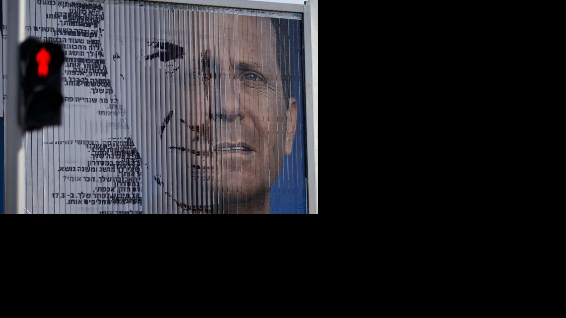
In this photo taken Thursday, March 5, 2015, an election campaign billboard shifts between images of Isaac Herzog, leader of the Labor Party, right, and Israel's Prime Minister Benjamin Netanyahu and leader of the Likud Party, in Tel Aviv, Israel. As no candidate is likely to win big in the wild jumble of Israel's political landscape, the outcome of the March 17 election could well be a joint government between Netanyahu and his moderate challenger Isaac Herzog. 
