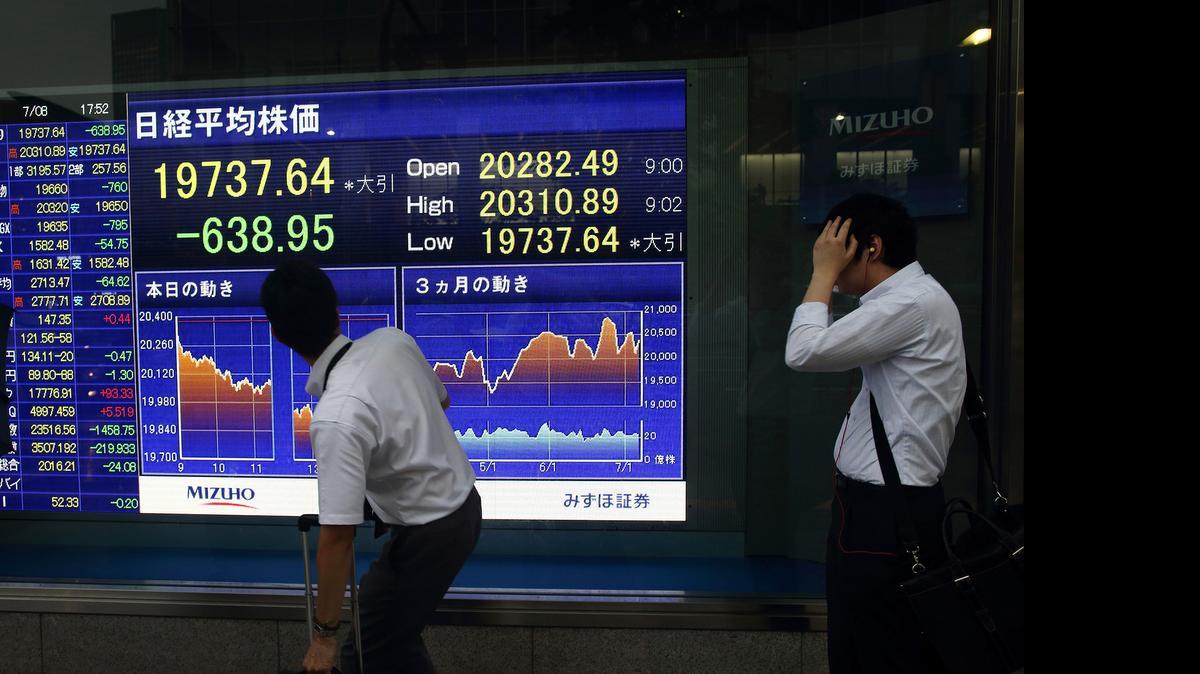 
An electronic stock board displays the closing figure of the Nikkei 225 Stock Average outside a securities firm in Tokyo on Wednesday. The Greek crisis diverted attention from the $3.2 trillion wiped in the first three weeks of China’s stock slump; now the deepening rout, which is sending losses spilling across Asia, is forcing investors to consider the global growth outlook. 
