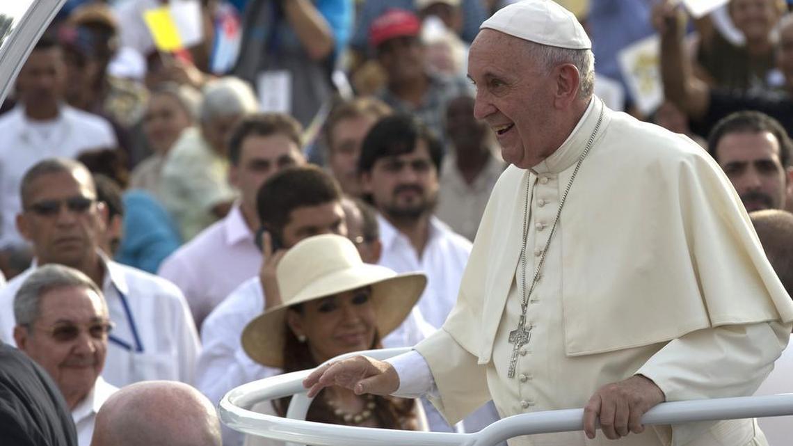 
Cuba’s President Raul Castro, behind left, and Argentina’s President Christina Fernandez, in hat, watch Pope Francis arrive for Mass at Revolution Plaza in Havana, Cuba, Sunday, Sept. 20, 2015. Pope Francis opened his first full day in Cuba on Sunday with what normally would be the culminating highlight of a papal visit: Mass before hundreds of thousands of people in Havana’s Revolution Plaza. 
