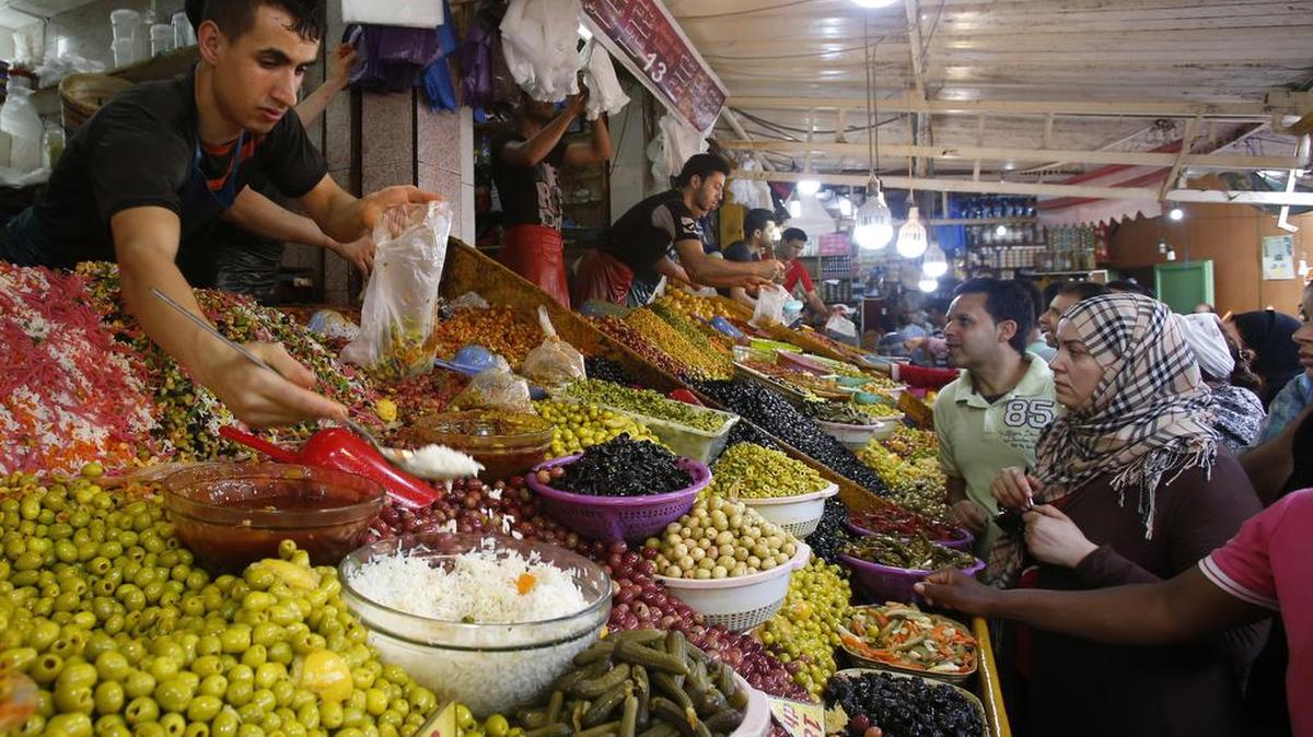 Moroccans buy olives and other goods in a souk market in Casablanca as they prepare to break their fast during the first day of the holy month of Ramadan. (AP Photo/Abdeljalil Bounhar)