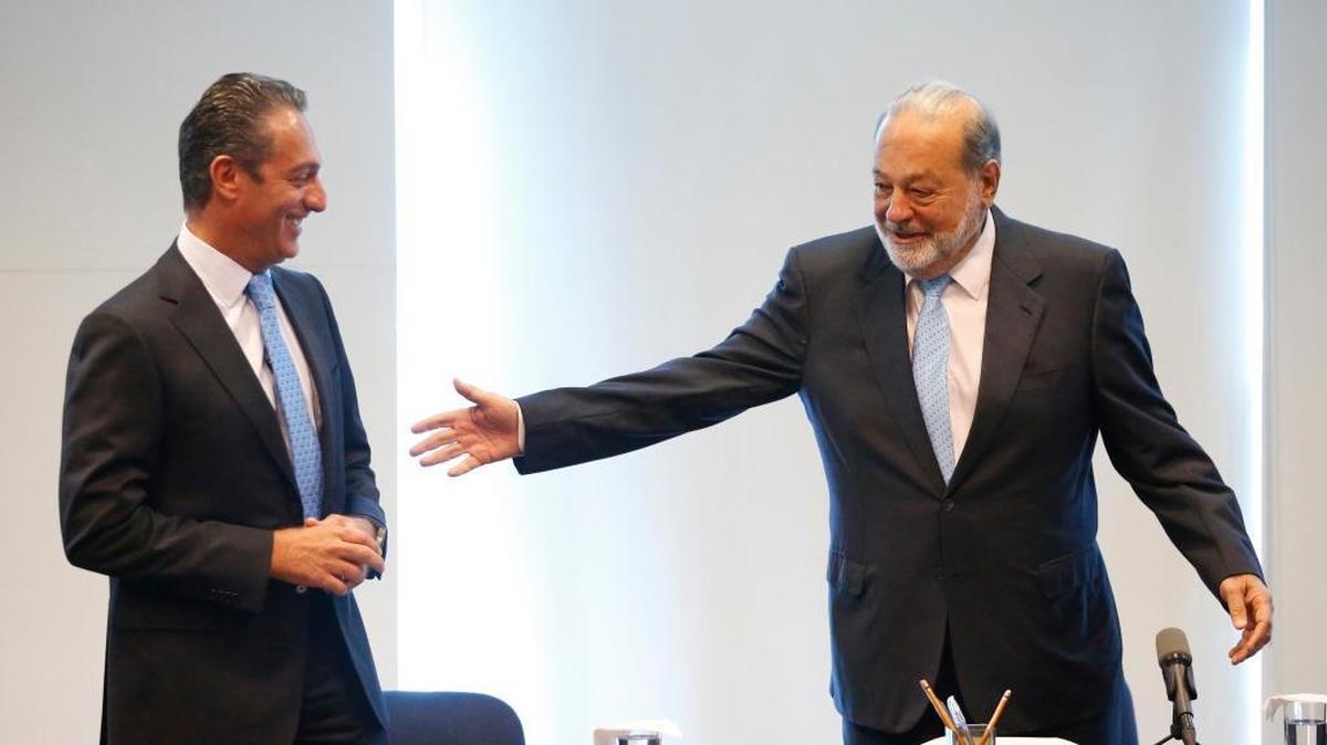 Mexican business magnate Carlos Slim, right, gestures to his son Carlos Slim Domit as they arrive for a news conference in Mexico City. Slim called for "national unity" in the face of Trump's hostility and said Mexico should have a measured response.