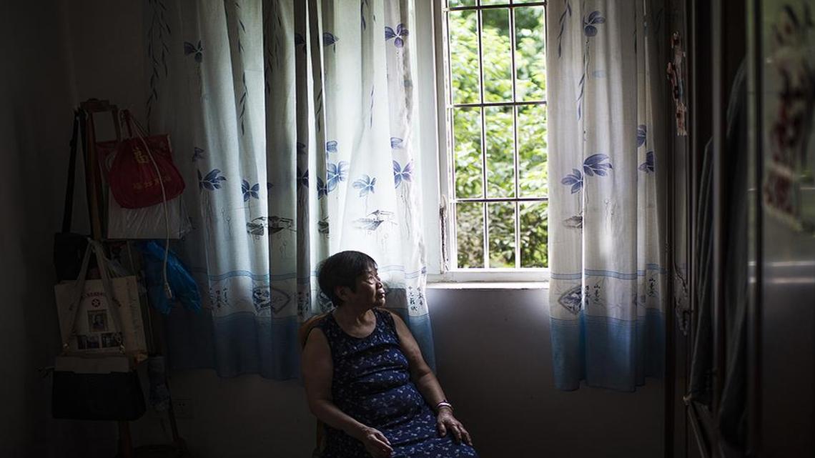 
Chen Guifang sits near the window in her apartment in Chongqing, China on Aug. 12, 2015. On May 4, 1939, 7-year-old Chen was huddled inside a crowded cave in Chongqing – China’s wartime capital in its southern interior – as Japan bombed the city for a second straight day. Shrapnel rocketed everywhere, wounding Chen and killing both of her parents. Nearly 12,000 died in the Japanese bombing of Chongqing during World War II.

