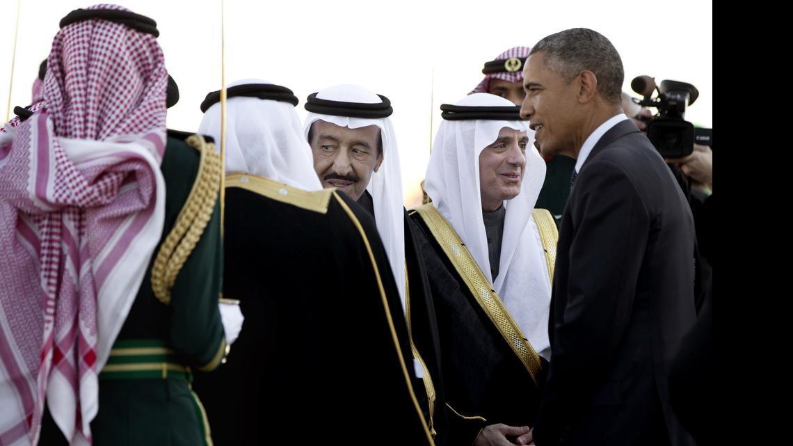 
In this Tuesday, Jan. 27, 2015, photo, President Barack Obama is greeted by new Saudi King Salman bin Abdul Aziz as the president and first lady Michelle Obama arrive on Air Force One at King Khalid International Airport, in Riyadh, Saudi Arabia. It is not just the Saudi king who will be skipping the Camp David summit of U.S. and allied Arab leaders. Most Gulf heads of state won't be there. 
