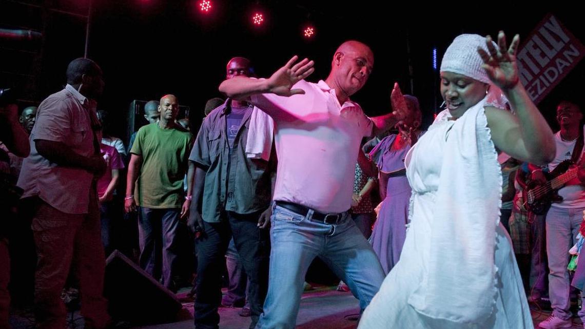 Michel Martelly dances with a band member that performed at his campaign rally in Gonaives, Haiti, in 2011. The dancing continued while in office.