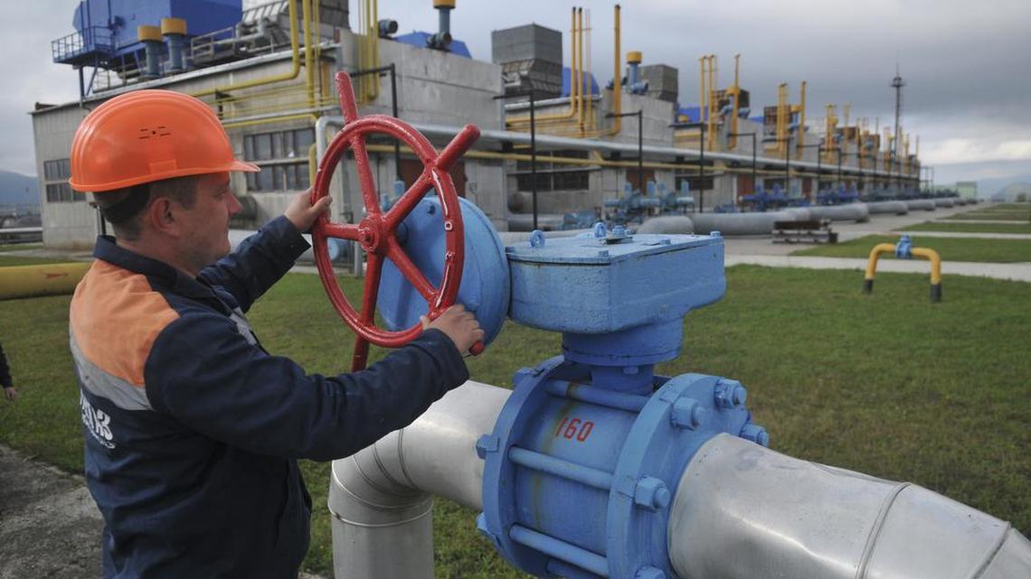 In this Wednesday, Oct. 7, 2015 file photo, a worker at a Ukrainian gas station Volovets in western Ukraine controls a valve. The Russian state-controlled gas company is halting supplies to Ukraine, its chief executive said Wednesday, Nov. 25, 2015.