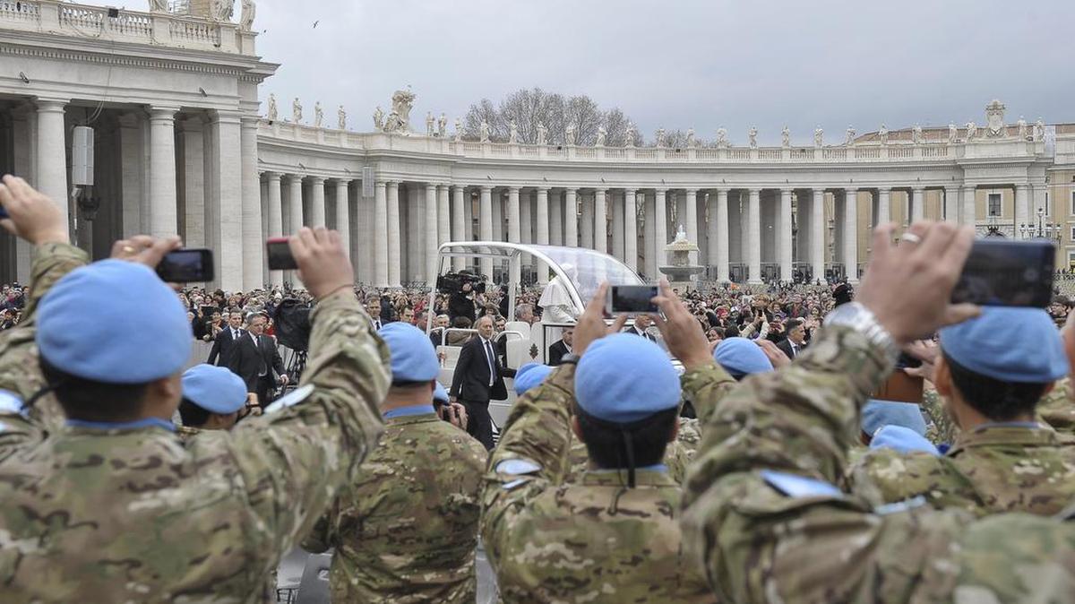 United Nations soldiers from Argentina and deployed in Cyprus, take photos of Pope Francis, upon his arrival in St. Peter's Square at the Vatican, Wednesday, Feb. 3, 2016.