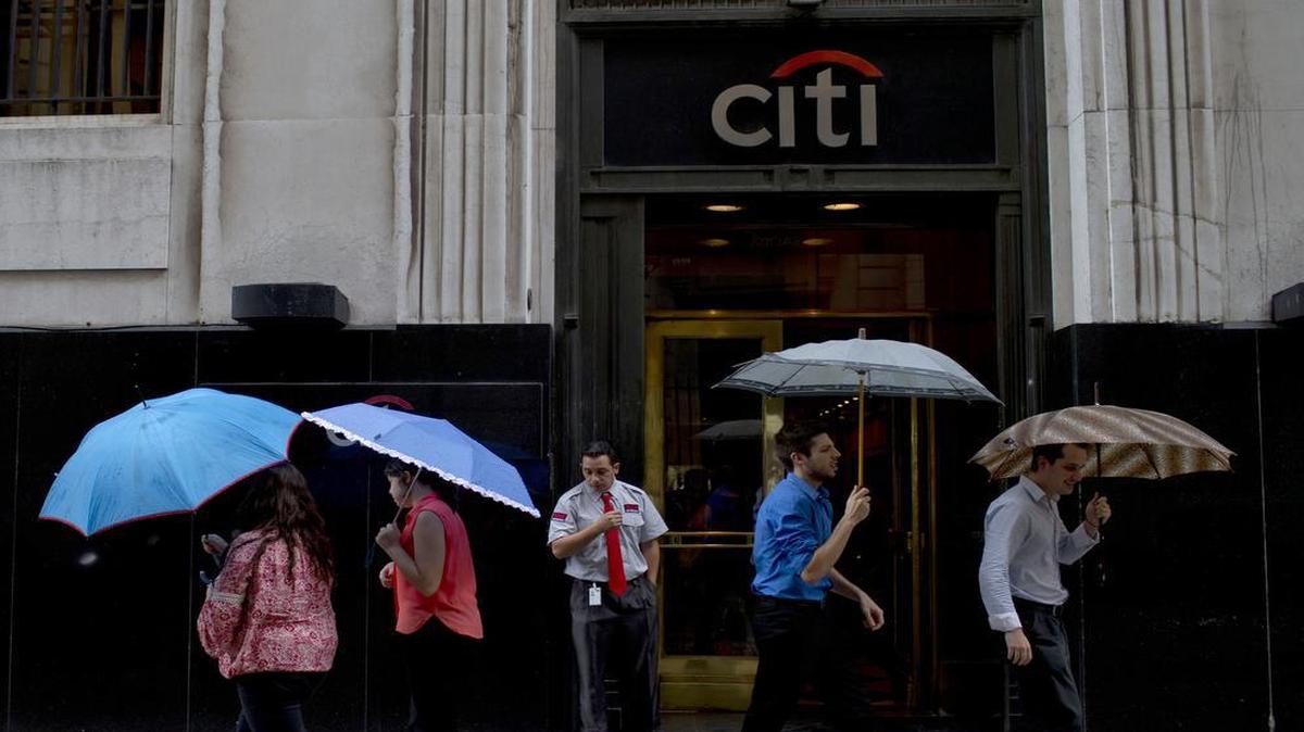 People pass by Citibank offices in Buenos Aires. Citibank says it will sell its direct banking operations it’s had for a century in Argentina, Brazil and Colombia at a time when the three largest economies in South America are suffering setbacks.