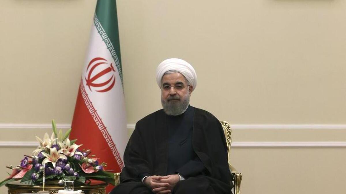 
Iranian President Hassan Rouhani, beneath portraits of the late Iranian revolutionary founder Ayatollah Khomeini and current Supreme Leader Ayatollah Ali Khamenei. Has Iran left its revolutionary roots behind?
