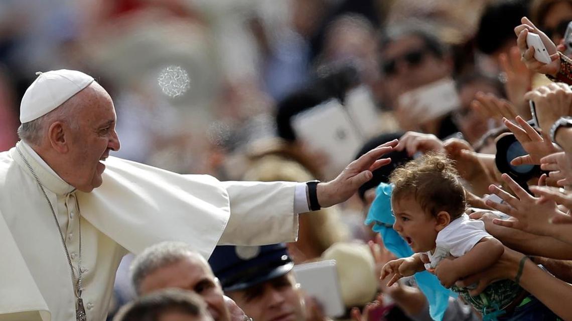 
Pope Francis blesses a child as he arrives for the weekly general audience in St. Peter's Square at the Vatican, Wednesday, Sept. 16, 2015. 
