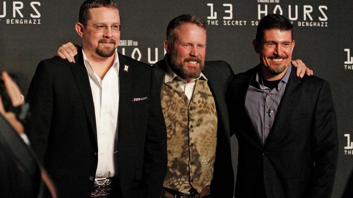 Real-life Benghazi security contractors John “Tig” Tiegan, Mark “Oz” Geist and Kris “Tanto” Paronto have fun on the red carpet during the premiere of “13 Hours: The Secret Soldiers of Benghazi at AT&T Stadium in Arlington, Texas, on Tuesday.