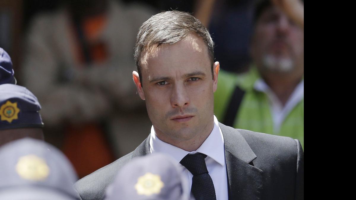 
In this Friday, Oct. 17, 2014 photo, Oscar Pistorius is escorted by police officers as he leaves the high court in Pretoria, South Africa.
