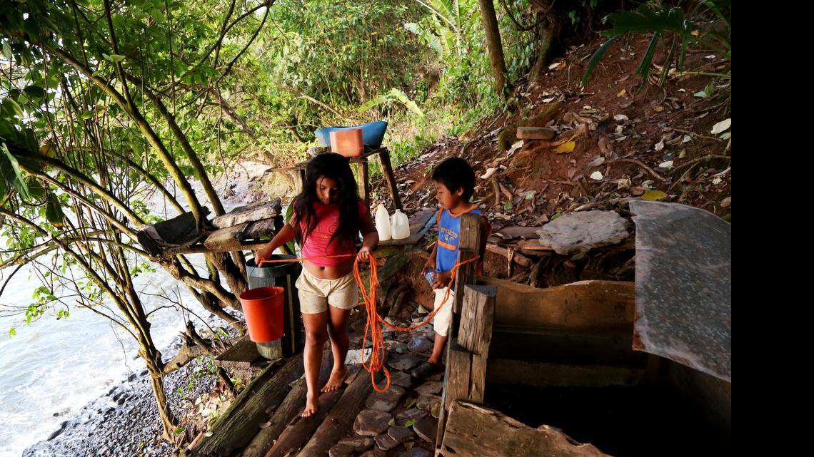 Children gather water for bathing in the morning in the Rama Indian village, Bangkukuk. If the Nicaragua canal is built, construction designs indicate a massive container port will be built right on the shore of Bangkukuk. Photo taken March 18, 2015.