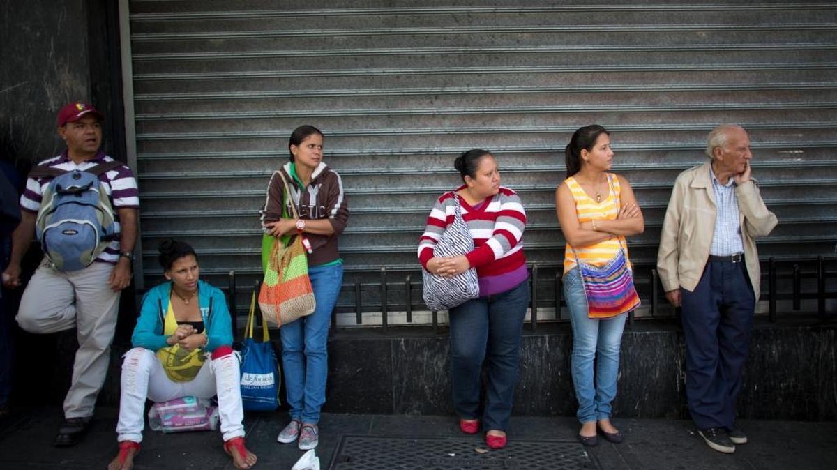 People wait in line to buy groceries at government-regulated prices in Caracas, Venezuela. Low oil prices are wreaking havoc and causing uncertainty for some governments and businesses in Latin America but opening an opportunity for U.S. officials to press their country’s energy agenda.