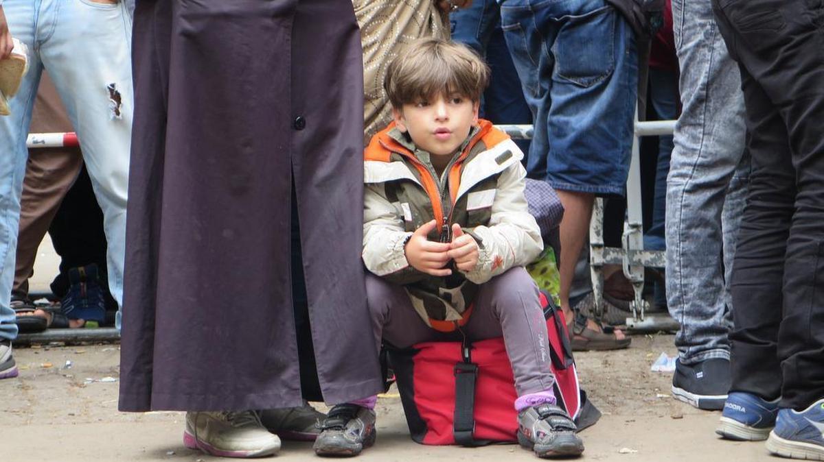 
Many children are among hundreds of refugees waiting in the courtyard of the Berlin Office for Health and Social Affairs.
