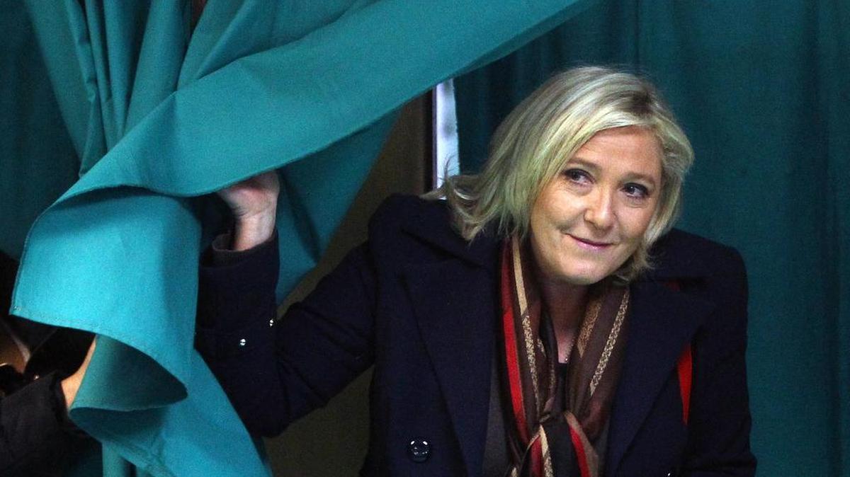 French far-right National Front party leader Marine Le Pen exits from a polling booth before voting for the second round of regional elections on Sunday, Dec. 13, 2015, in Henin-Beaumont, northern France. Le Pen’s far-right party was the frontrunner after last Sunday’s first round, and now it’s up to voters whether to hand the once-pariah party an unprecedented political victory.