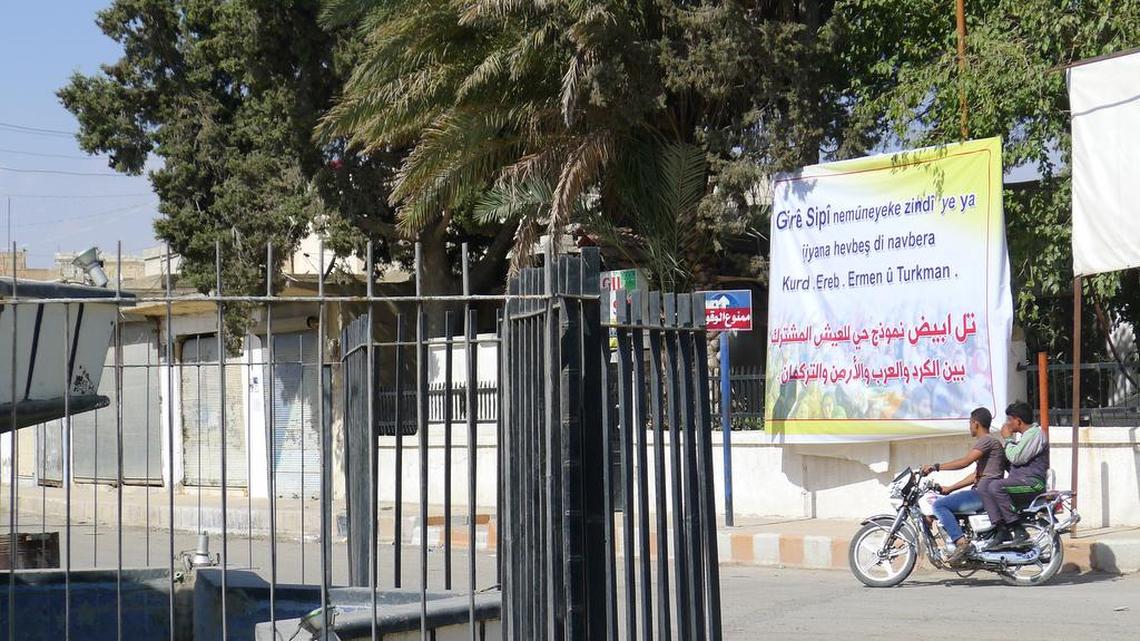 Until June, Islamic State extremists used this fenced-in fountain on a main traffic circle in Tal Abyad to behead those they labeled criminals or enemies of the state. Today, a banner outside the city’s municipal headquarters uses the city’s Kurdish name, Giri Spi, to declare it “the living symbol of coexistence between Kurds, Arabs, Armenians and Turkmans.”