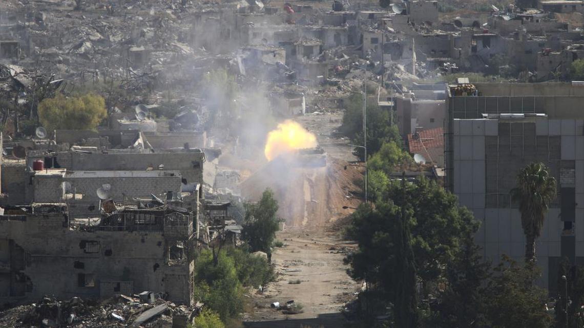 
A Syrian army tank fires during fighting in Jobar, Damascus, Syria, on Oct. 14, 2015. 
