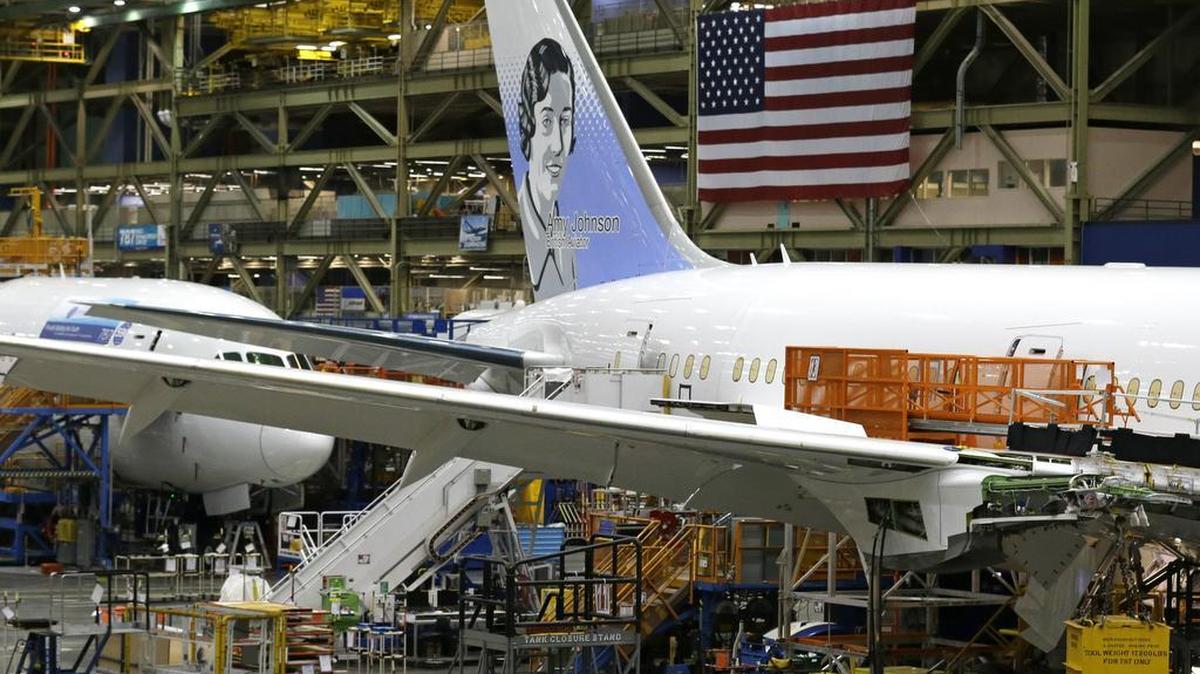 A U.S. flag is displayed above a Boeing 787 airplane being built for Norwegian Air Shuttle at Boeing Co.'s assembly facility, in Everett, Wash., in July.