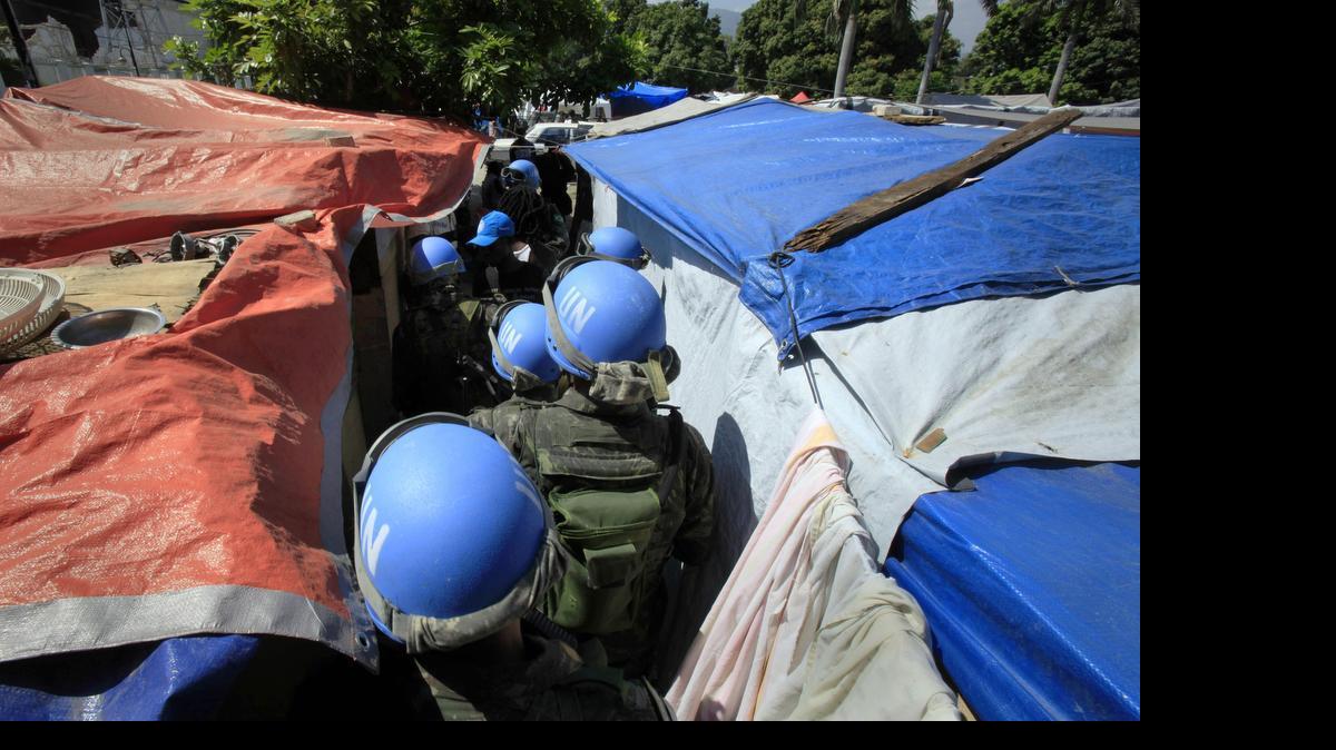 
United Nations peacekeepers patrol an earthquake survivors makeshift camp in Port-au-Prince on March 30, 2010. In 2015, troubled by peacekeepers' sexual relationships with the people they are meant to protect, the UN has quietly started helping with DNA collection to prove paternity claims for so-called "peacekeeper babies." 
